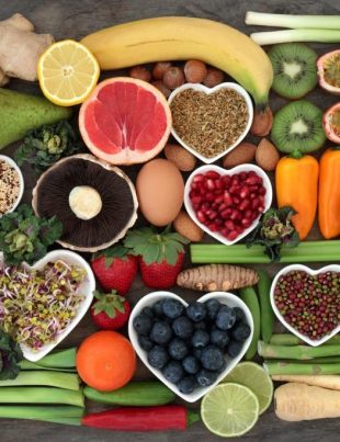 "Collection of healthy superfoods including blueberries, spinach, salmon, avocado, nuts, yogurt, and broccoli for a healthy lifestyle."