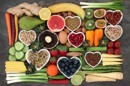 "Collection of healthy superfoods including blueberries, spinach, salmon, avocado, nuts, yogurt, and broccoli for a healthy lifestyle."