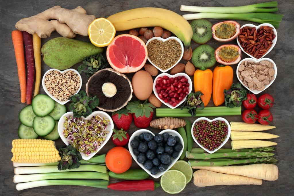 "Collection of healthy superfoods including blueberries, spinach, salmon, avocado, nuts, yogurt, and broccoli for a healthy lifestyle."